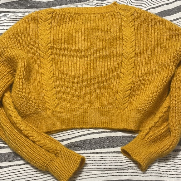 The color of the cardigan is yellow with buttons down the middle. - Picture 4 of 7